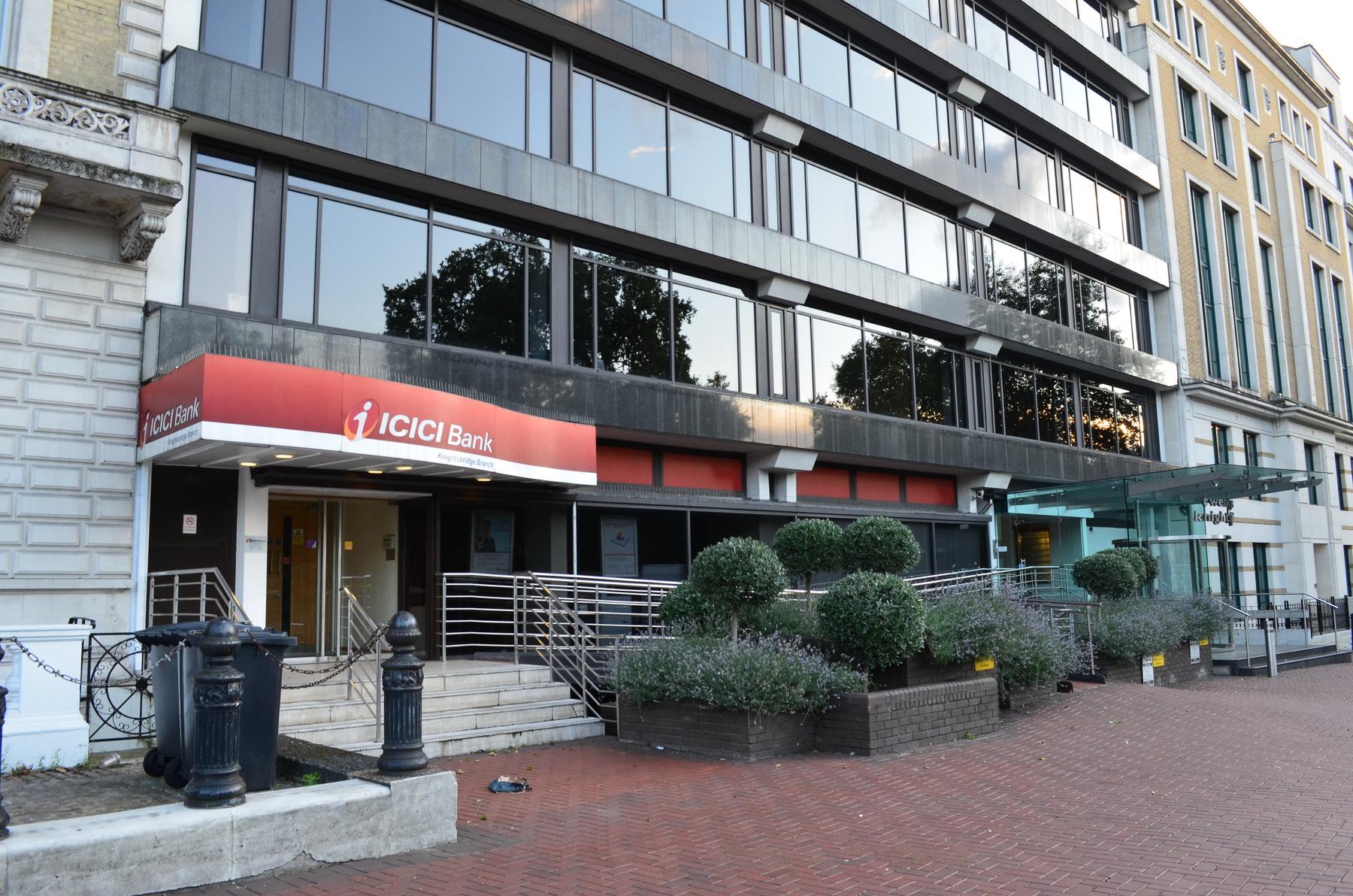 a building with a red and white sign that says cicli - ICICI Bank Branch in Knightsbridge, London